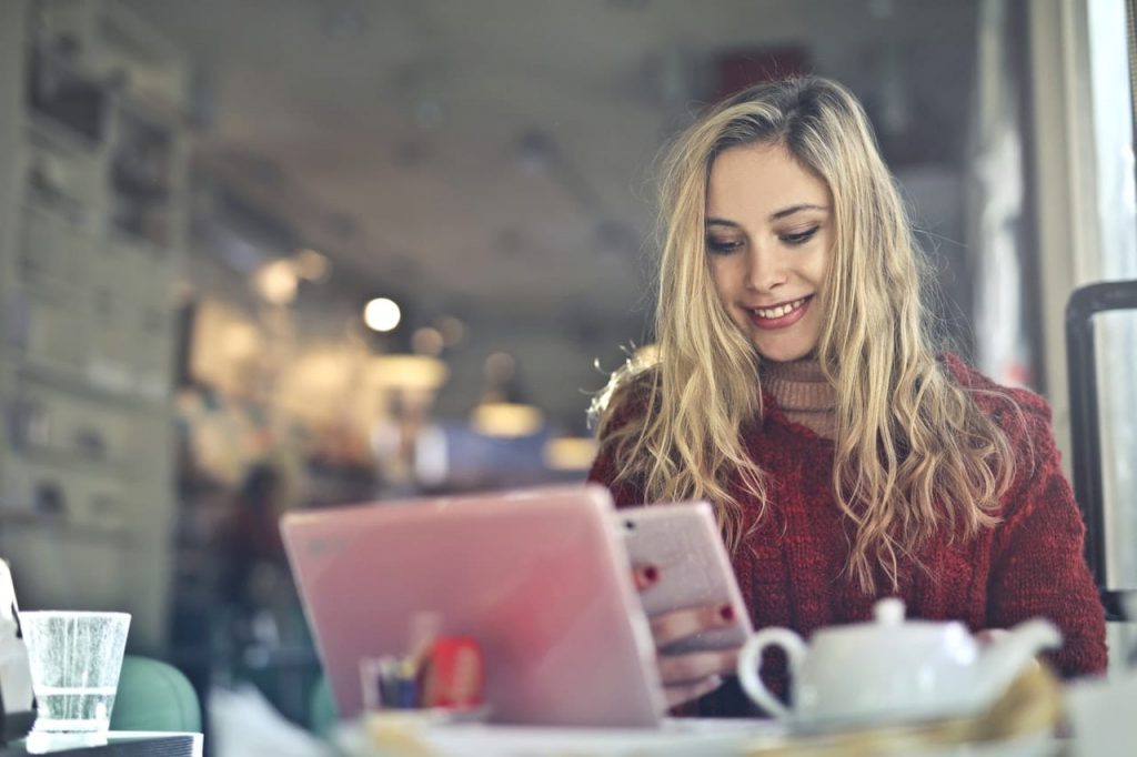 Unternehmerin freut sich über eine E-Mail mit schönen Grüßen